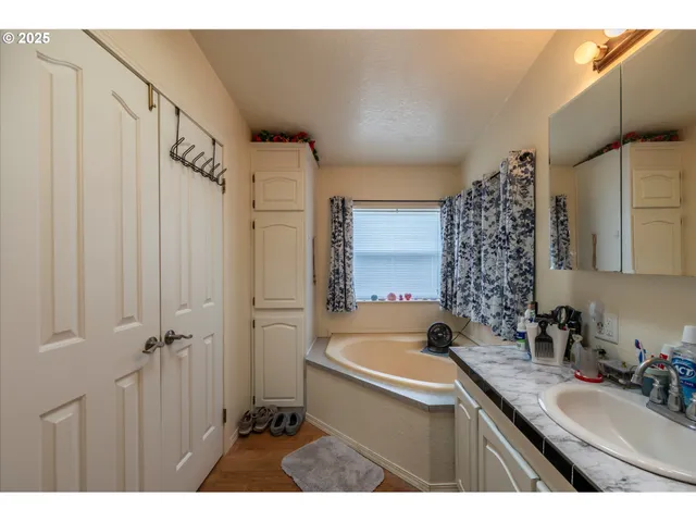a bathroom with a sink a mirror and a bathtub