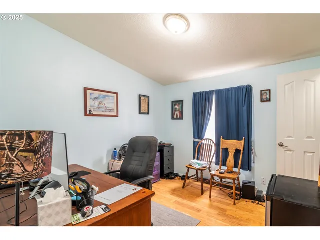 a living room with furniture and a piano