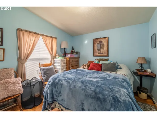 a bed room with a bed window and a chair