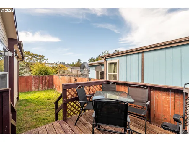 a view of a chairs and table in the balcony