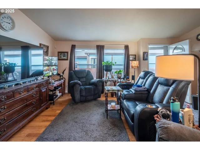 a living room with furniture a rug and a large window