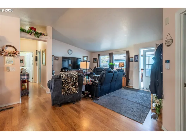 a living room with furniture and a wooden floor