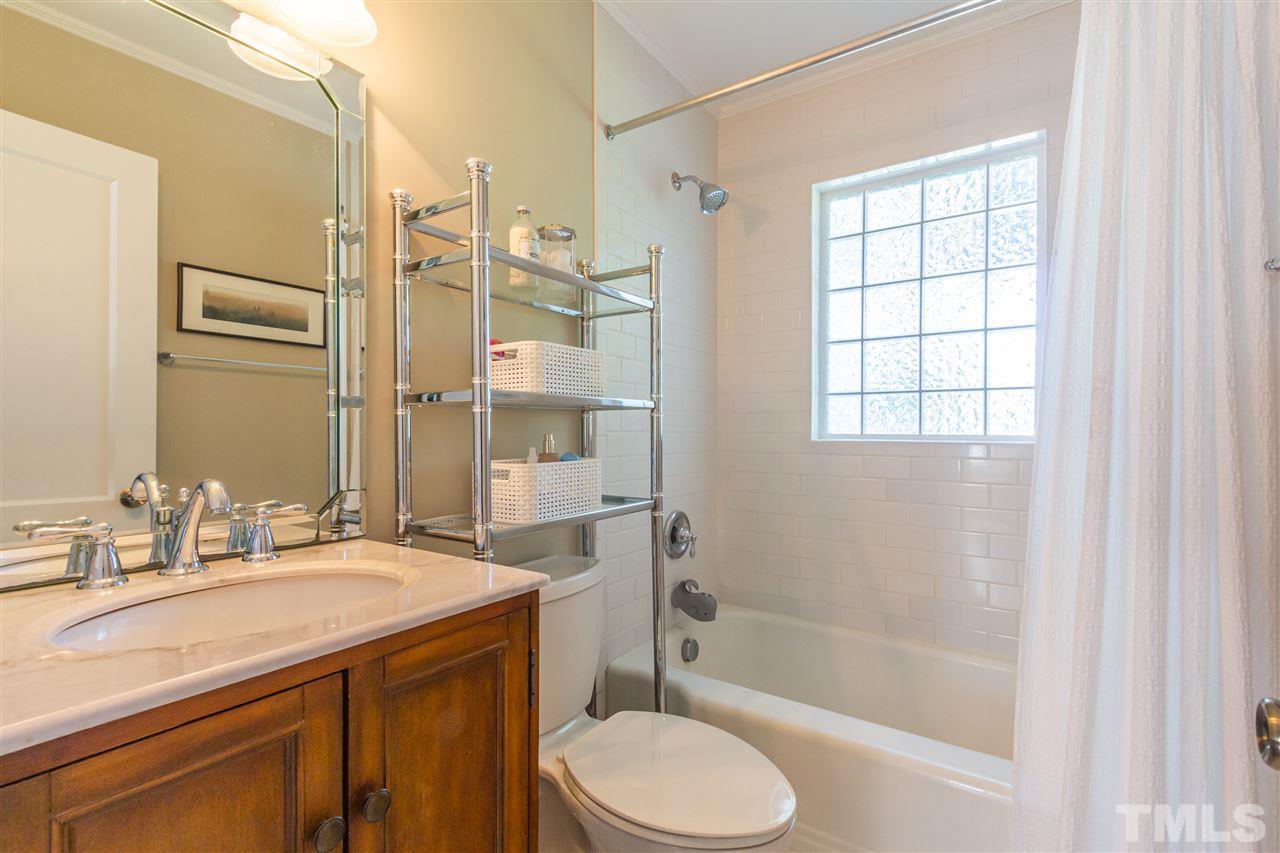 1230 Clifton Street Raleigh, NC 27604 - Photo 14 of 19 a bathroom with a sink a toilet and shower