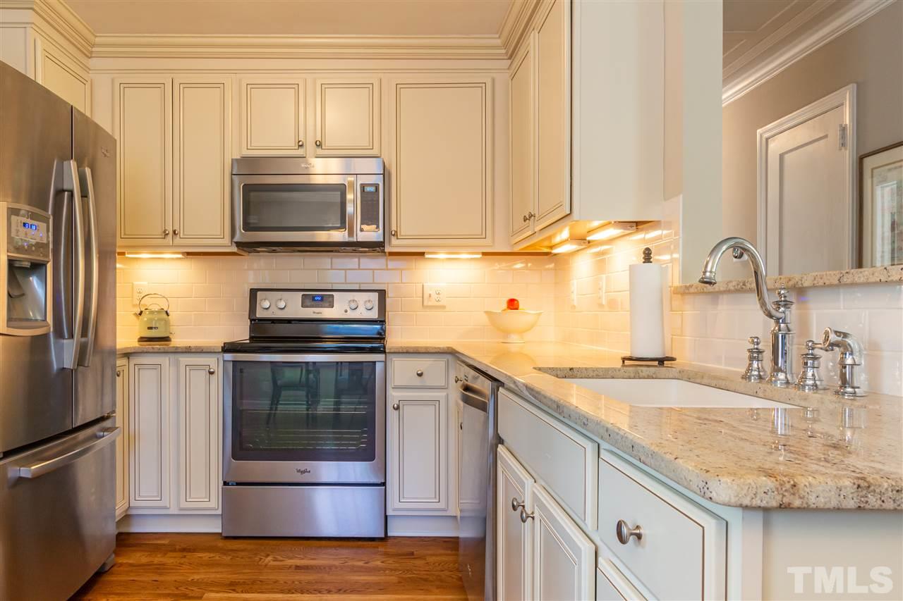 1230 Clifton Street Raleigh, NC 27604 - Photo 6 of 19 a kitchen with stainless steel appliances granite countertop a sink stove and refrigerator