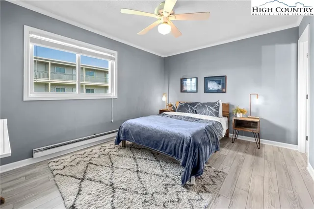 a spacious bedroom with a bed and a window