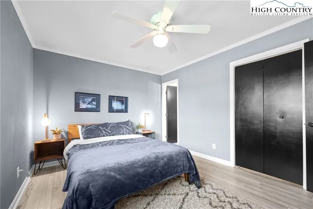 a bedroom with a large bed and a chandelier