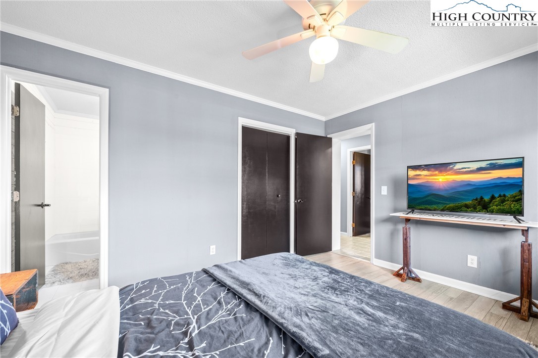 301 Pinnacle Inn Road, Unit 3207 Beech Mountain, NC 28604 - Photo 17 of 37 a bedroom with furniture and a chandelier