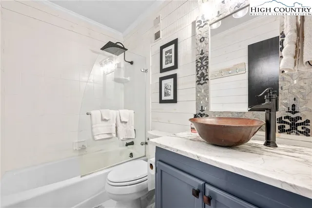 a bath room with a toilet a sink and a bath tub