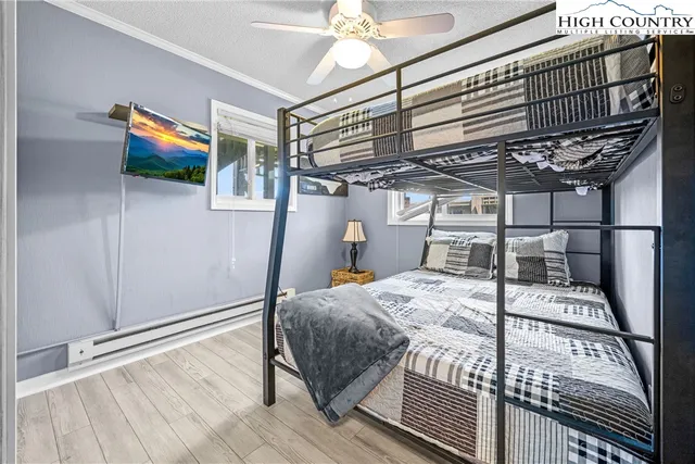 a bed sitting in a bedroom next to a window