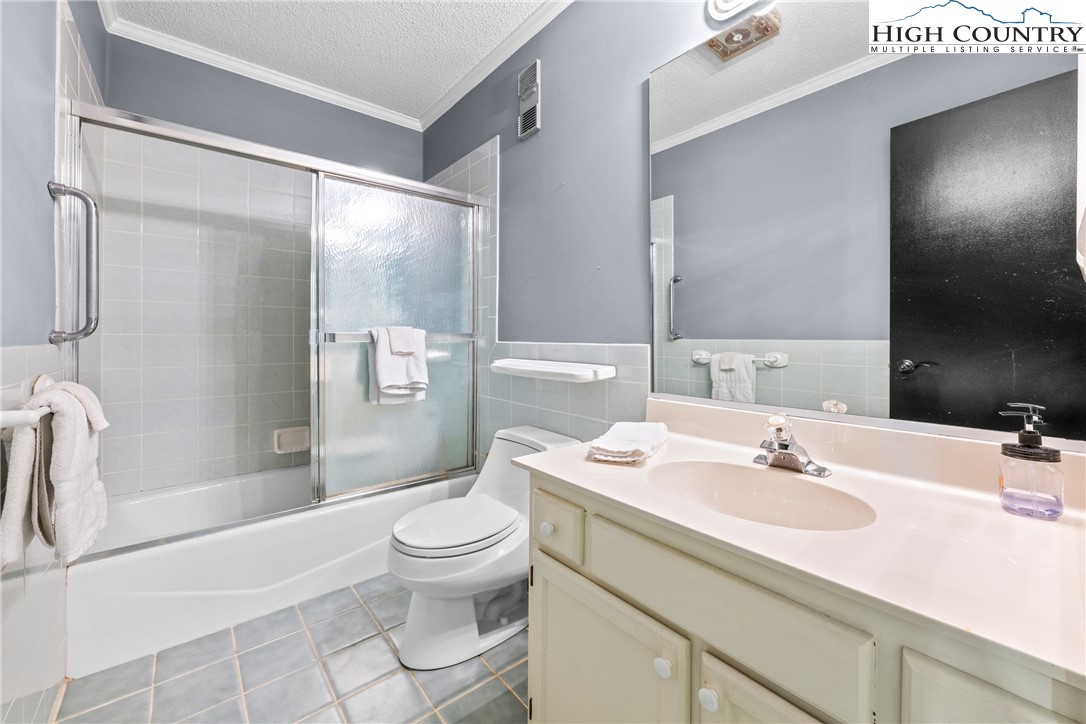 301 Pinnacle Inn Road, Unit 3207 Beech Mountain, NC 28604 - Photo 21 of 37 a bathroom with a sink toilet and shower