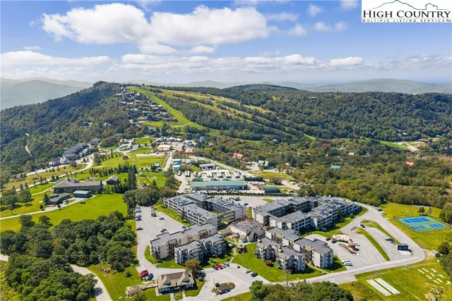 a kitchen with stainless steel appliances granite countertop a sink refrigerator and cabinets