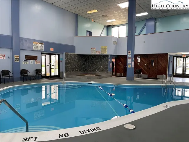 a room with pool table and windows