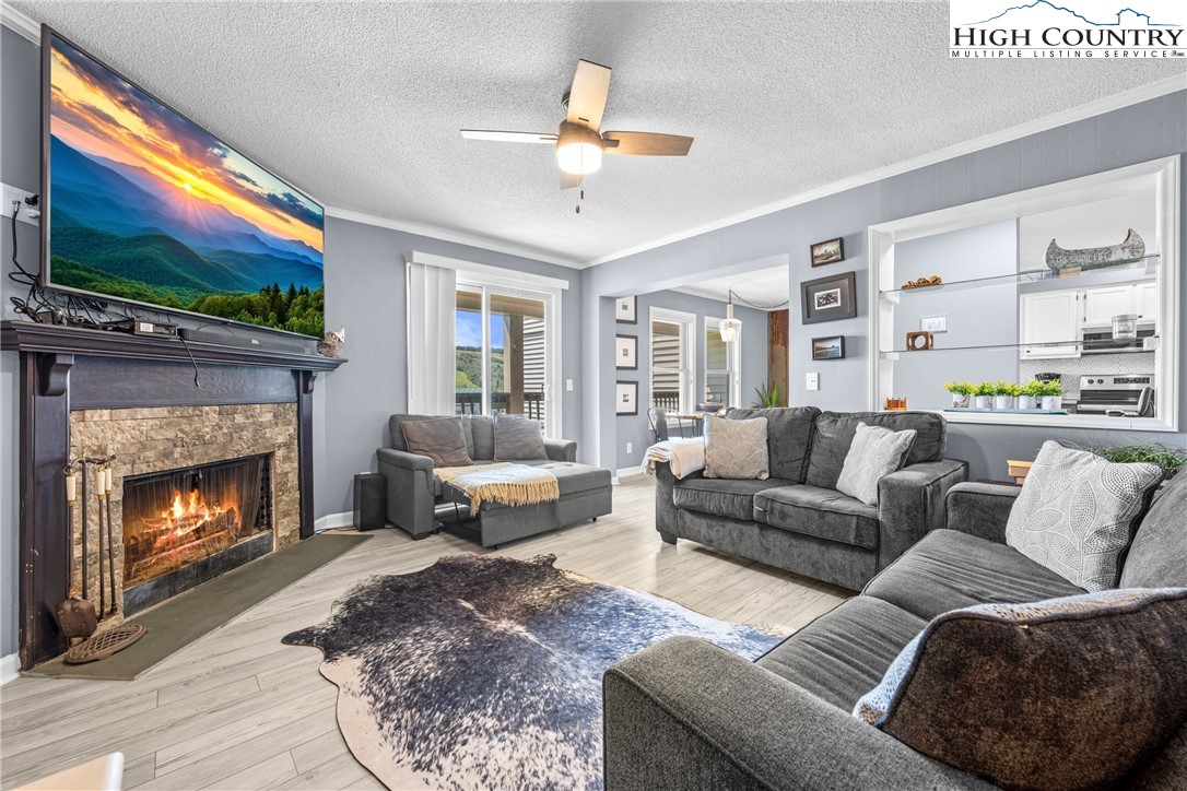 301 Pinnacle Inn Road, Unit 3207 Beech Mountain, NC 28604 - Photo 4 of 37 a living room with furniture and a fireplace