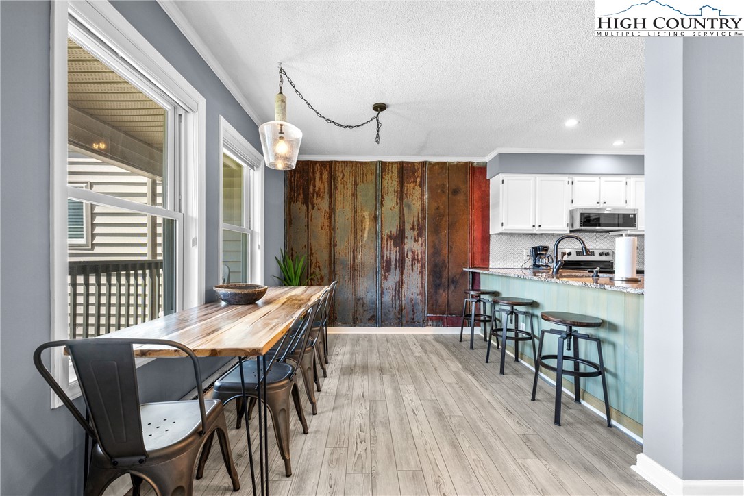 301 Pinnacle Inn Road, Unit 3207 Beech Mountain, NC 28604 - Photo 7 of 37 a view of a dining room with furniture window and wooden floor