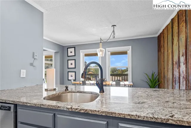 a kitchen with granite countertop a sink and a window