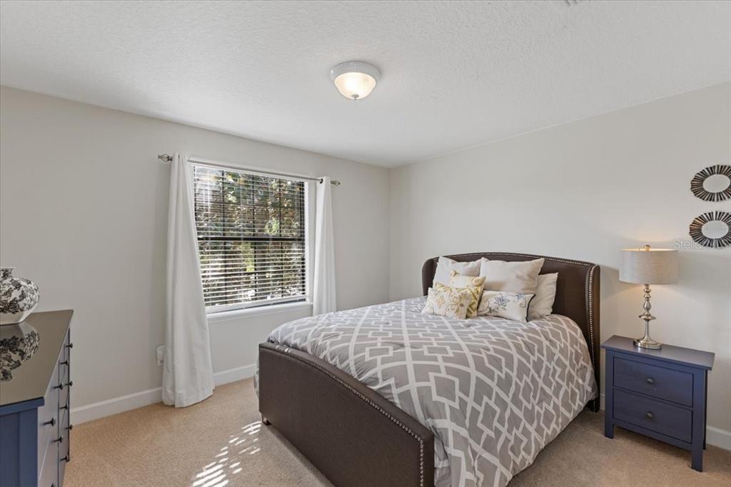 7180 Beek Street Windermere, FL 34786 - Photo 19 of 33 a bedroom with a bed and a window