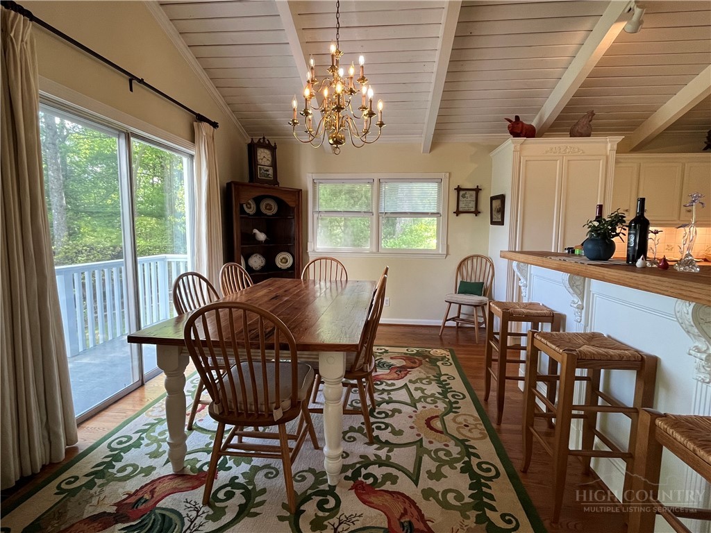 638 Ridge Road Glade Valley, NC 28627 - Photo 10 of 44 a view of a dining room with furniture a chandelier and wooden floor