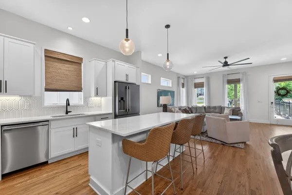 a large kitchen with stainless steel appliances lots of counter space and a sink