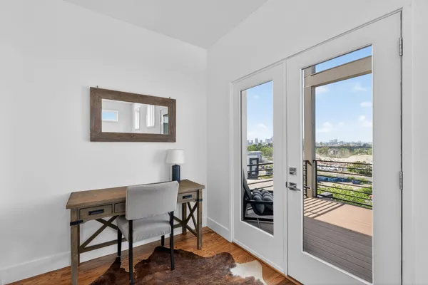 a balcony with chairs and wooden floor