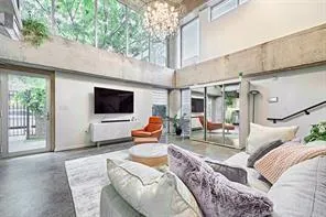 a living room filled with furniture and a flat screen tv