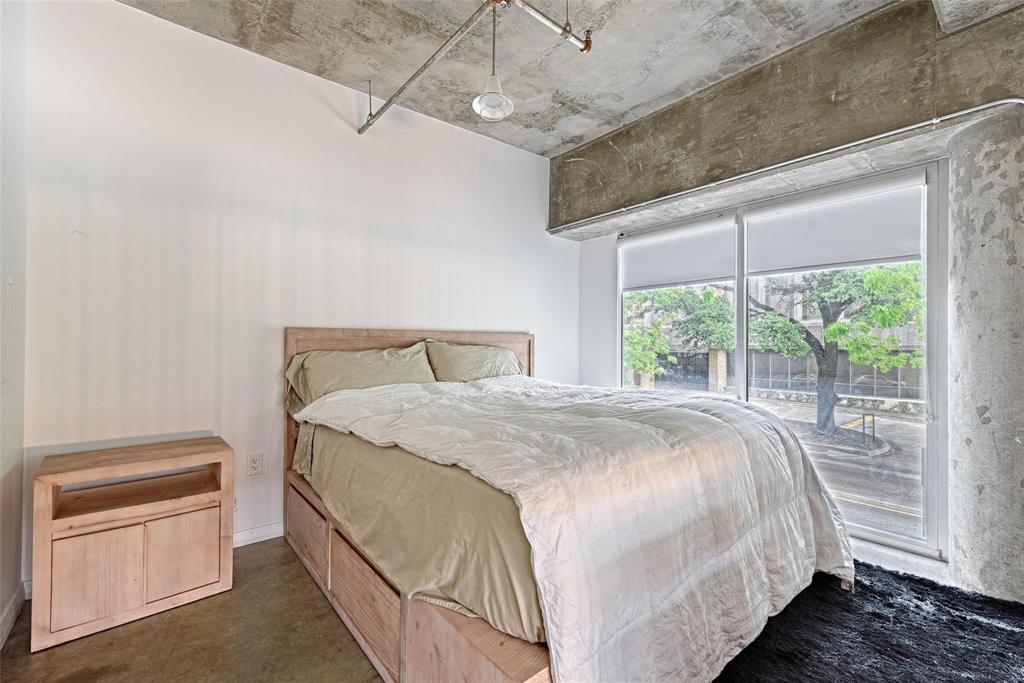 1001 Belleview Street, Unit 104 Dallas, TX 75215 - Photo 15 of 22 a bedroom with a large bed and a window