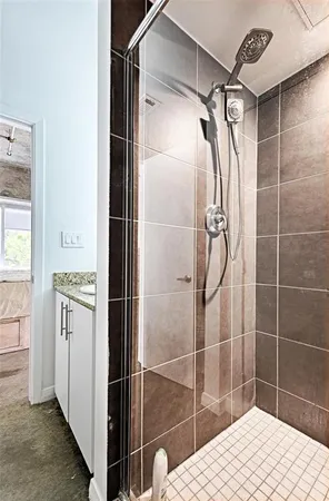 a bathroom with a shower and a sink