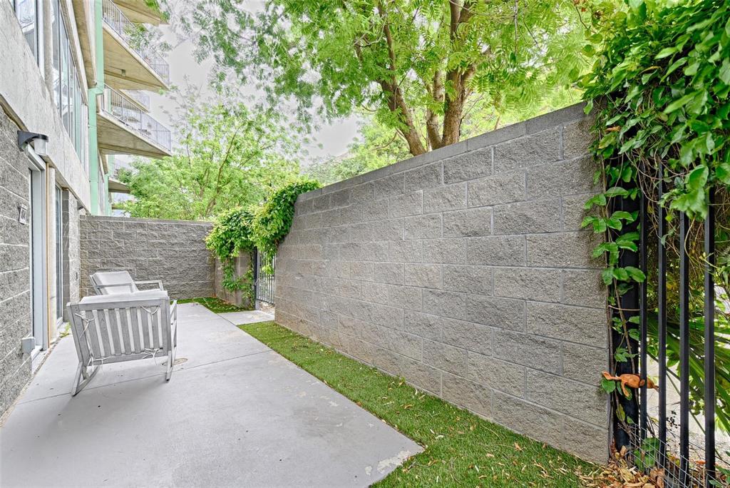 1001 Belleview Street, Unit 104 Dallas, TX 75215 - Photo 3 of 22 a view of a chair and table in backyard of the house
