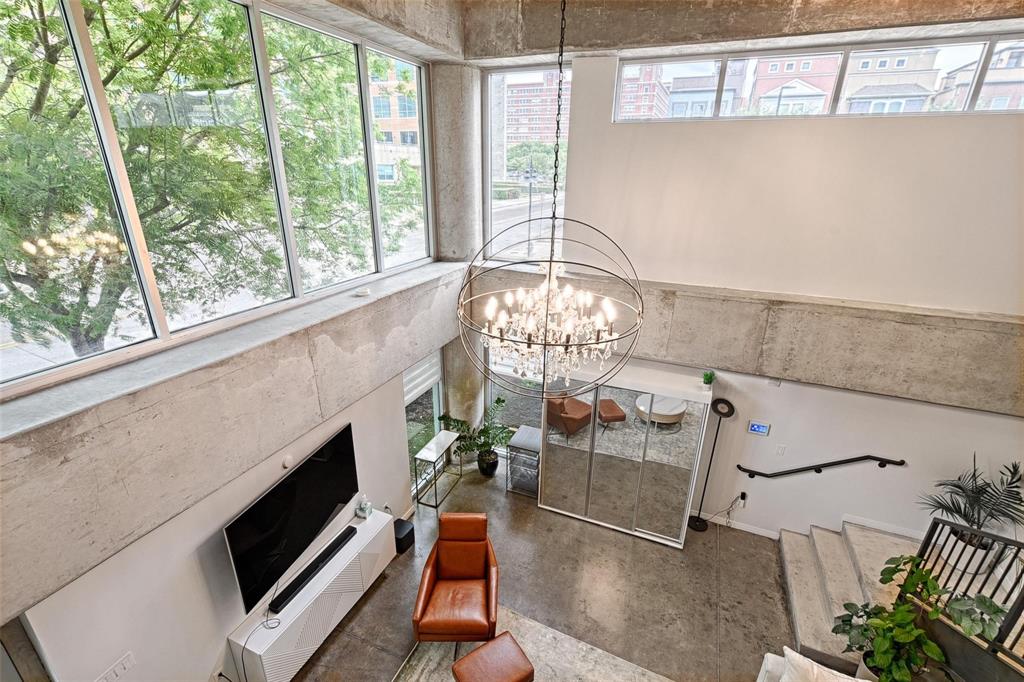 1001 Belleview Street, Unit 104 Dallas, TX 75215 - Photo 9 of 22 a living room with furniture a fireplace and a floor to ceiling window