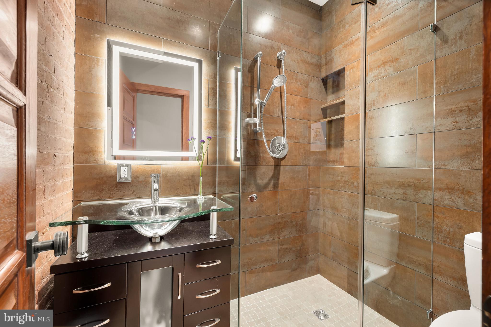1436 Q Street Northwest Washington, DC 20009 - Photo 16 of 45 a bathroom with a sink a toilet and shower