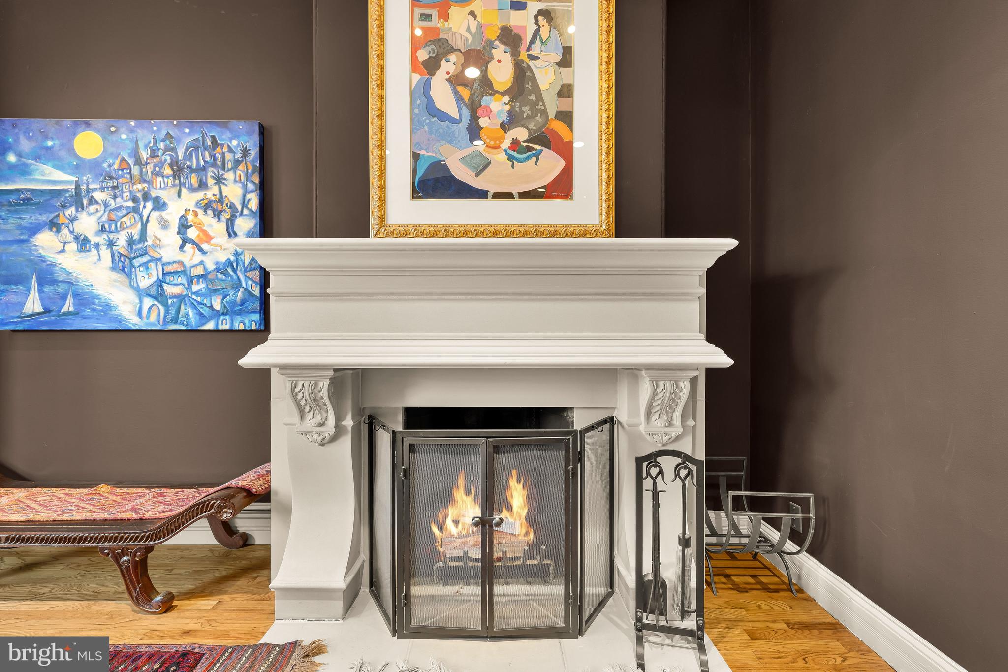 1436 Q Street Northwest Washington, DC 20009 - Photo 21 of 45 a view of a fireplace with paintings on the wall