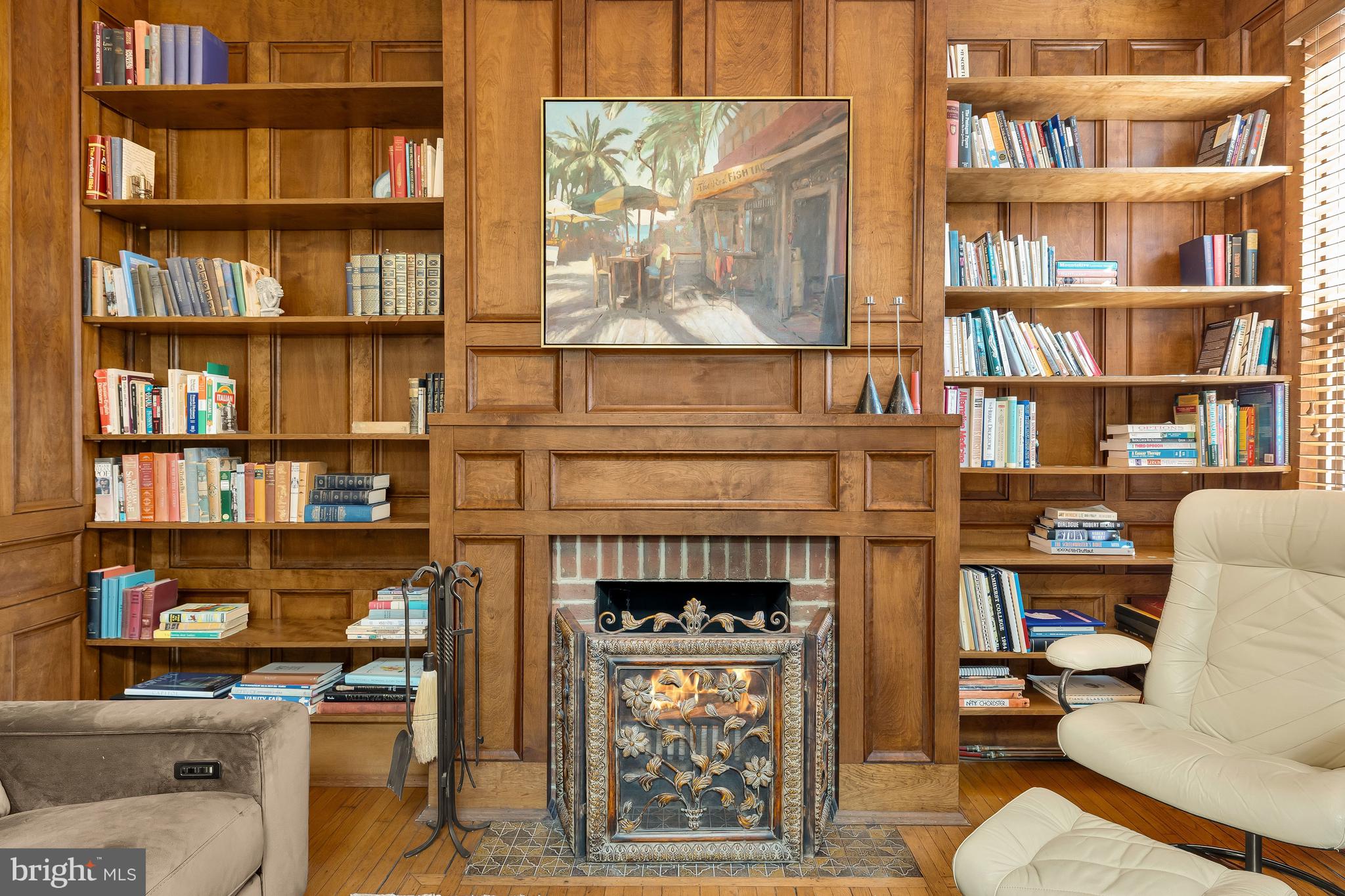 1436 Q Street Northwest Washington, DC 20009 - Photo 26 of 45 a living room with a bookshelf and a fireplace