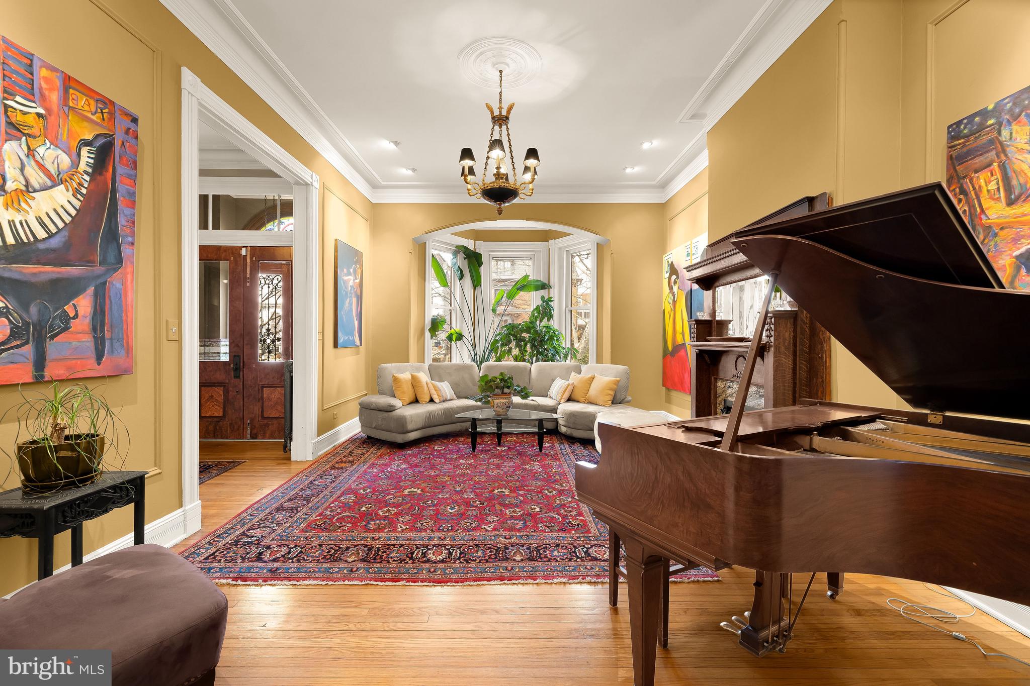 1436 Q Street Northwest Washington, DC 20009 - Photo 6 of 45 a living room with furniture a chandelier and a fireplace