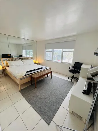 a room with pool table and windows