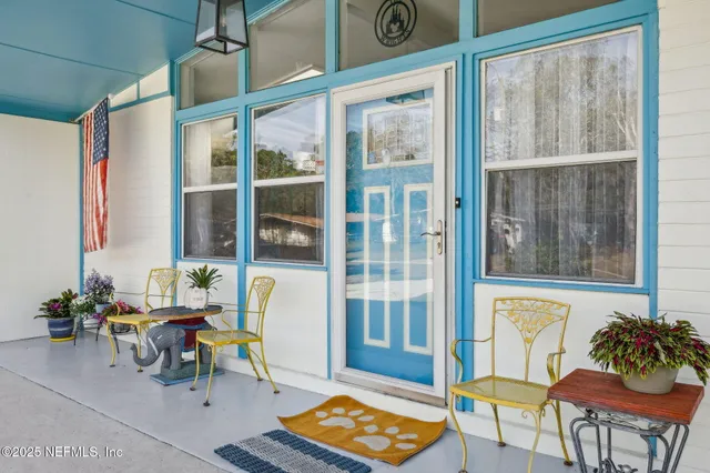 a kitchen with stainless steel appliances kitchen island granite countertop a stove a sink a dining table and chairs with wooden floor