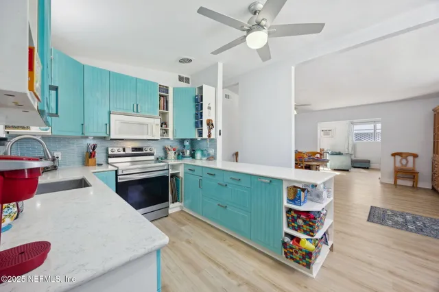 a living room with furniture and a ceiling fan