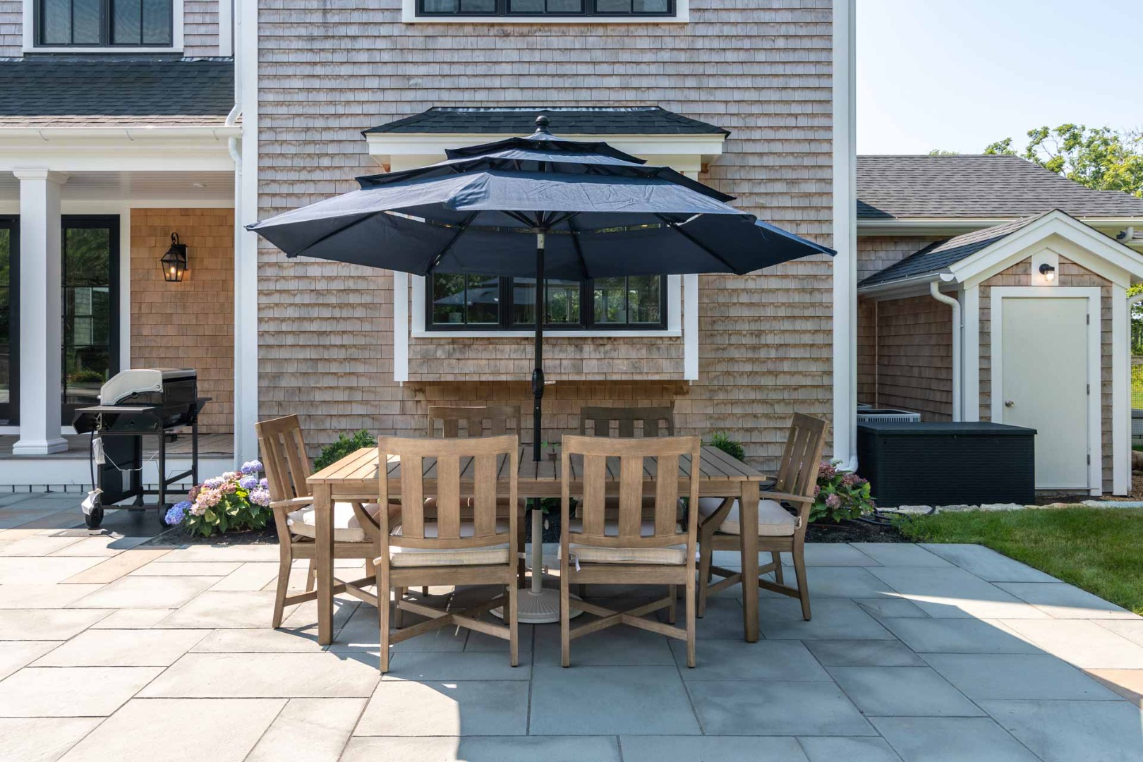61 Division Road Edgartown, MA 02539 - Photo 19 of 20 a view of a patio with table and chairs under an umbrella