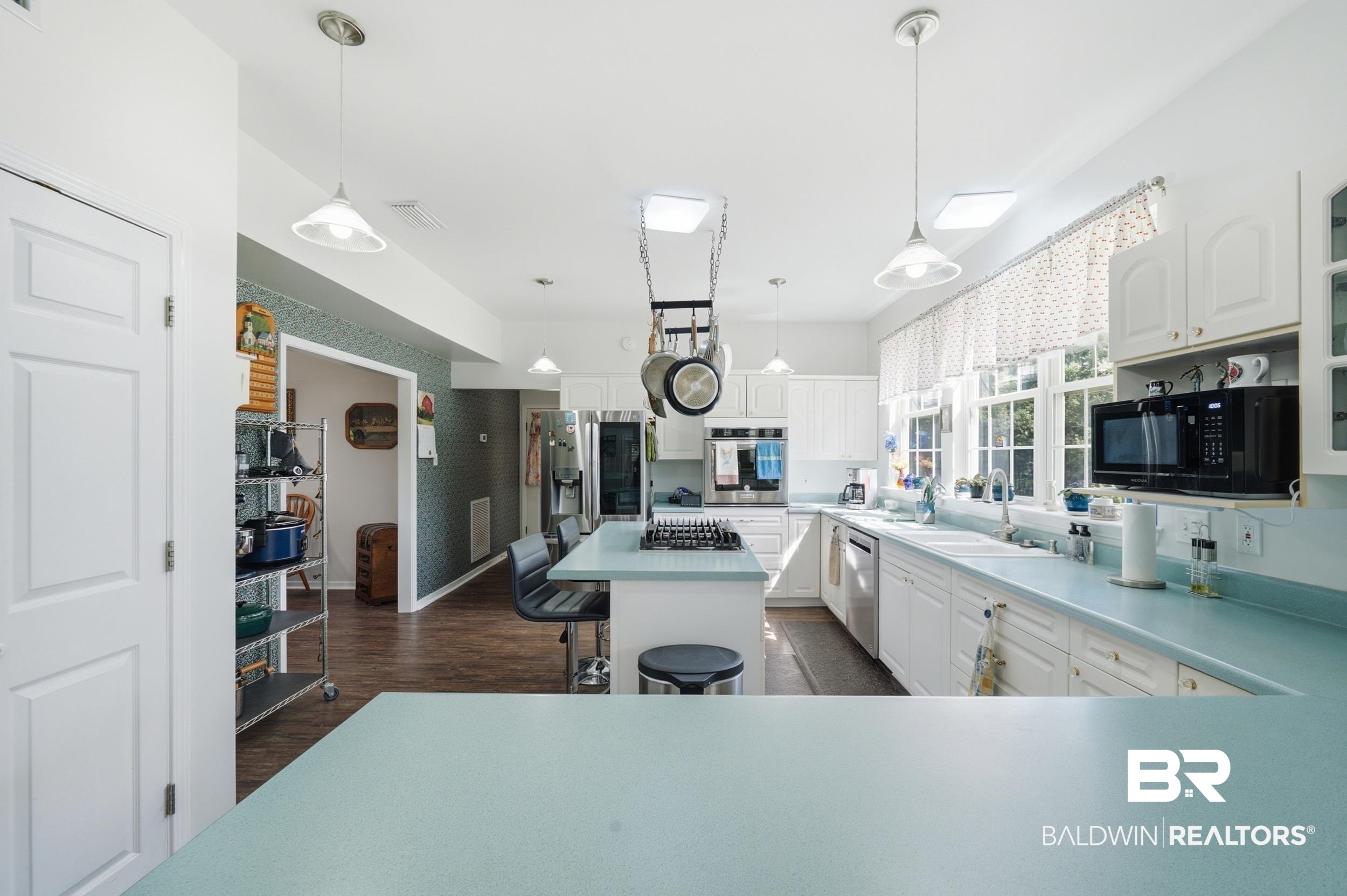 15855 Calvin Richerson Road Bay Minette, AL 36507 - Photo 24 of 83 Spacious kitchen featuring an expansive island with a gas cooktop, white cabinetry, light-toned countertops, and multiple skylights