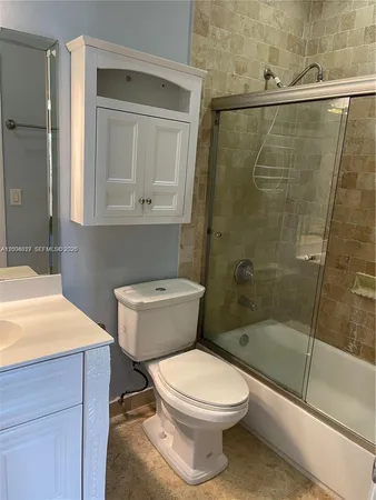 a bathroom with a toilet a sink and shower