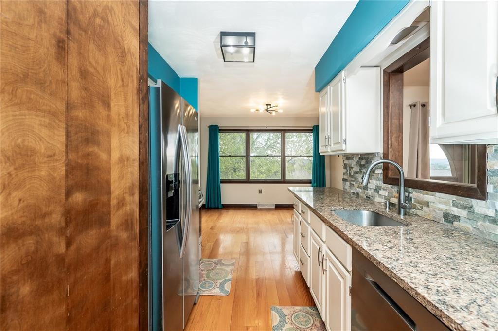 205 Briarwood Indiana, PA 15701 - Photo 11 of 23 a bathroom with a granite countertop sink and a large mirror next to a window