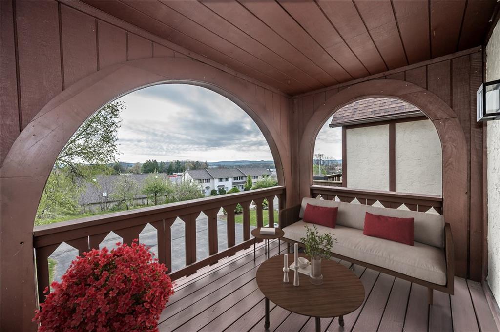205 Briarwood Indiana, PA 15701 - Photo 2 of 23 a balcony with wooden floor table and chairs
