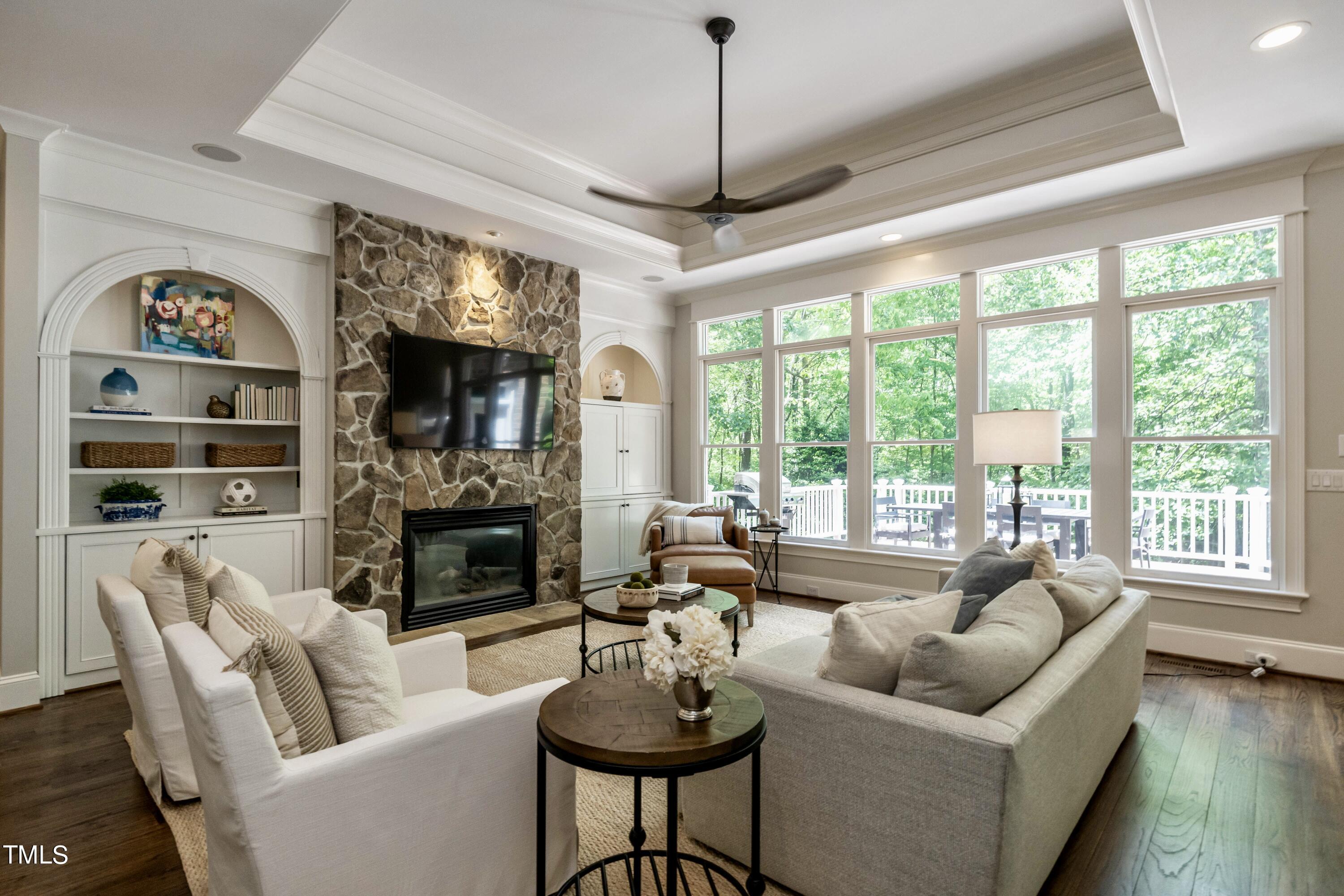 7209 Sunset Glen Point Raleigh, NC 27614 - Photo 12 of 44 a living room with furniture a large window and a fireplace