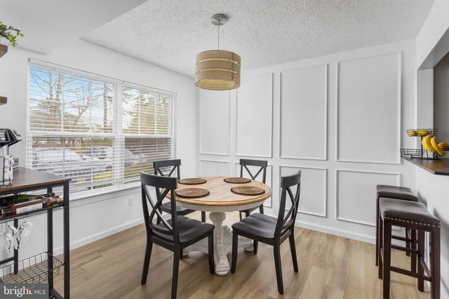a view of a dining room with furniture and window