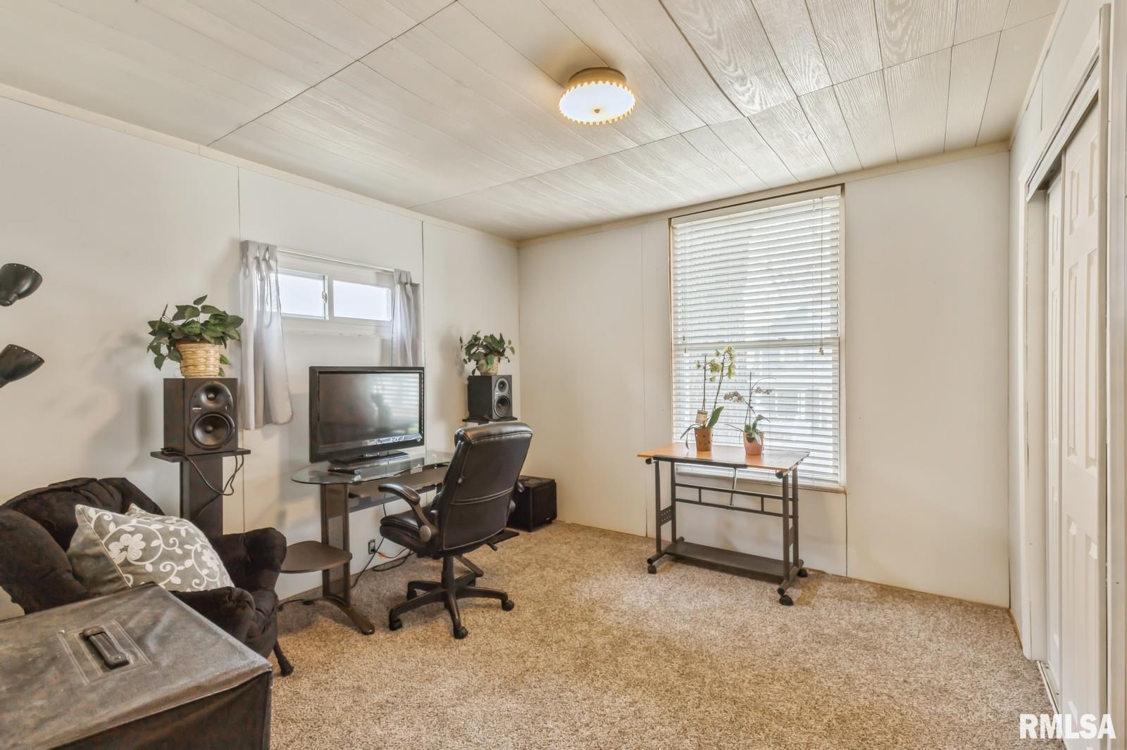 1301 Caroline Avenue Clinton, IA 52732 - Photo 12 of 19 a living room with furniture and a flat screen tv