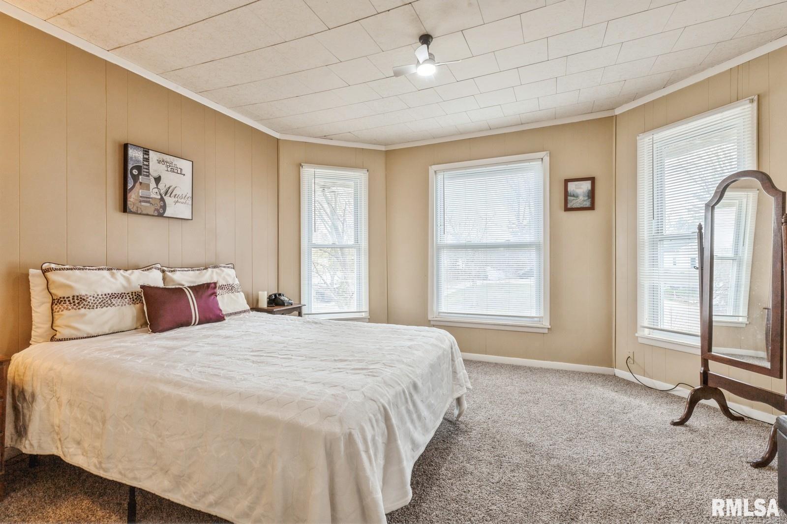 1301 Caroline Avenue Clinton, IA 52732 - Photo 13 of 19 a spacious bedroom with a large bed and a window