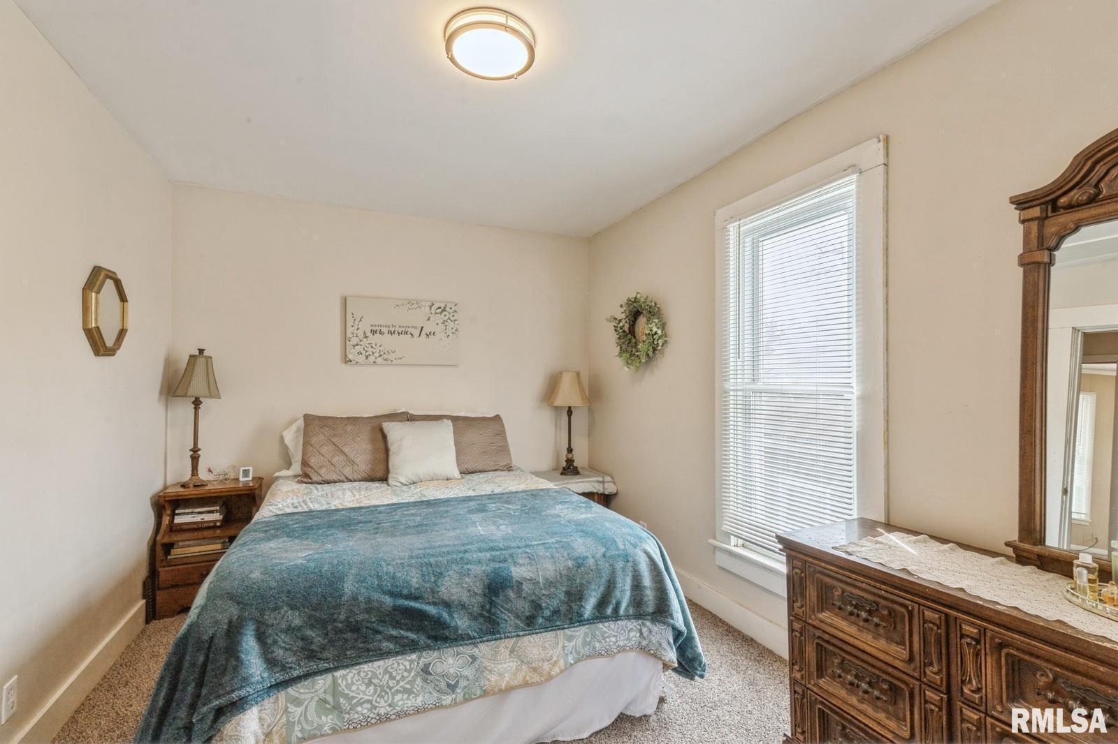 1301 Caroline Avenue Clinton, IA 52732 - Photo 14 of 19 a bedroom with a bed and a window