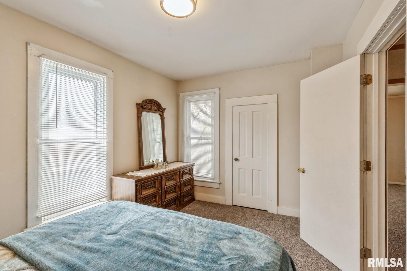 1301 Caroline Avenue Clinton, IA 52732 - Photo 15 of 19 a bedroom with a bed and a dresser