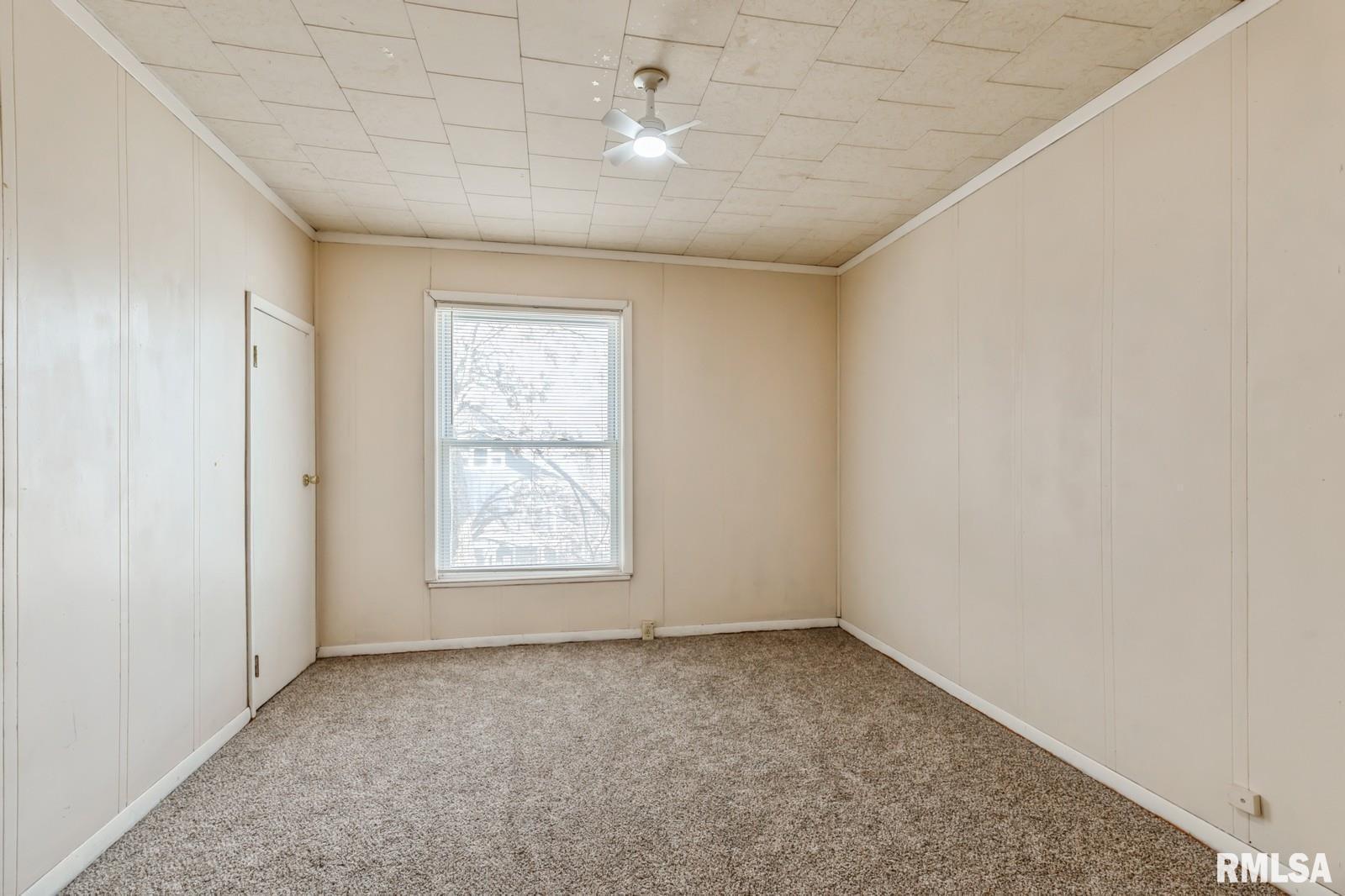 1301 Caroline Avenue Clinton, IA 52732 - Photo 16 of 19 an empty room with a window and a ceiling fan
