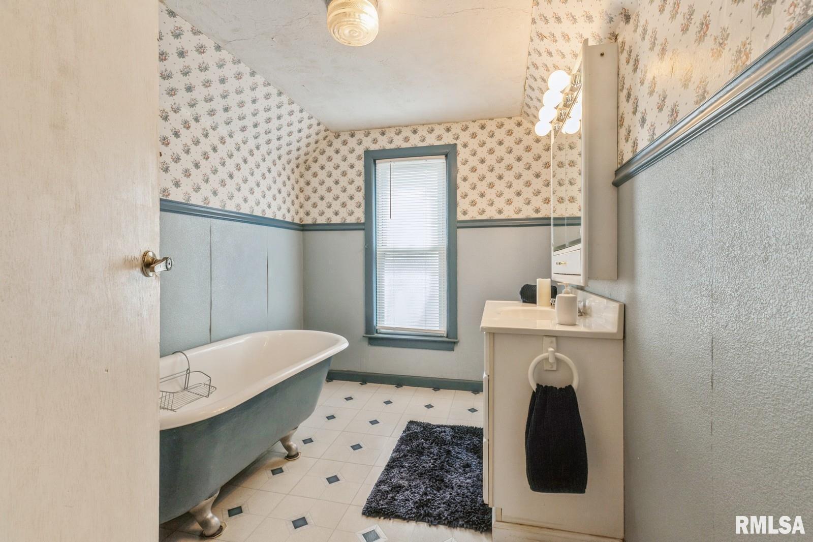 1301 Caroline Avenue Clinton, IA 52732 - Photo 17 of 19 a bathroom with a sink a toilet and mirror