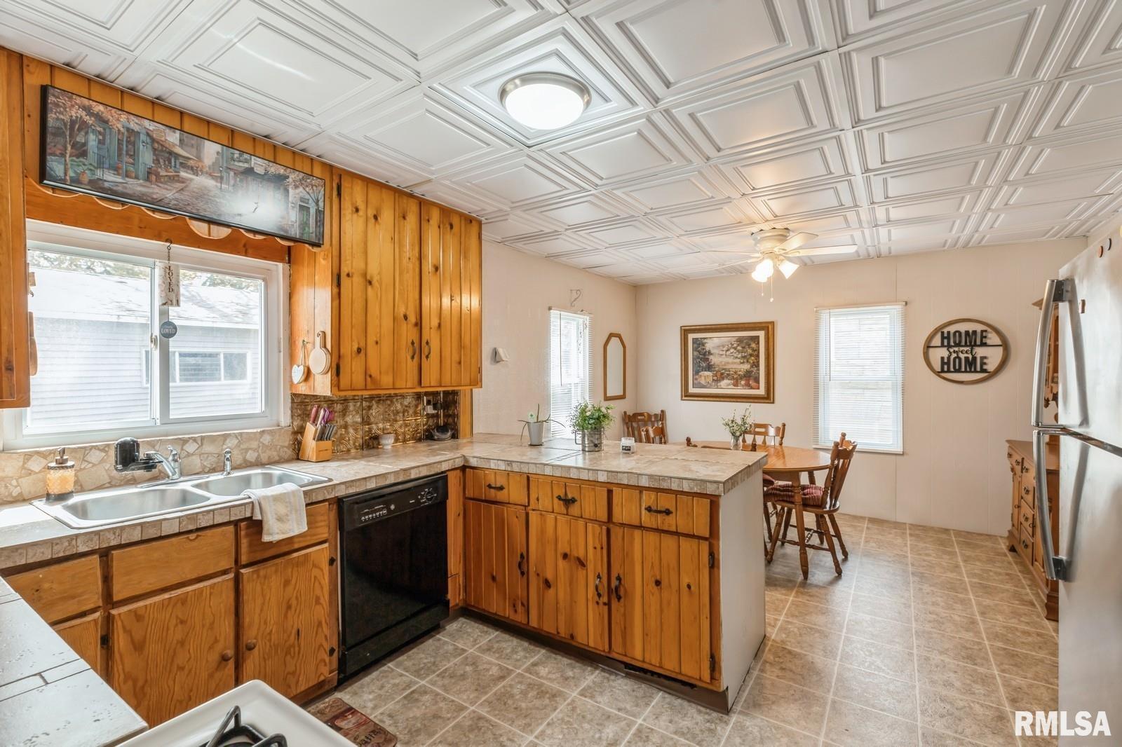 1301 Caroline Avenue Clinton, IA 52732 - Photo 6 of 19 a view of a kitchen area with furniture and window