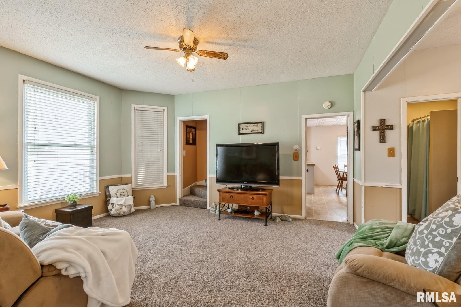 1301 Caroline Avenue Clinton, IA 52732 - Photo 9 of 19 a bedroom with furniture and a flat screen tv